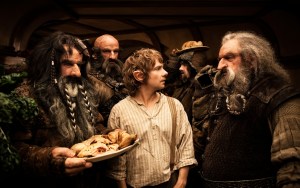 Bilbo (Martin Freeman) bewildered as the dwarves invade his home unexpectedly and immediately make themselves at home by gobbling down his food and liquer.