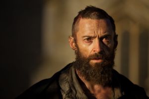 Jean Valjean (Hugh Jackman), looking like a scraggy vagabond, as a convicted criminal about to be released on parole.