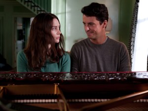 Charlie looking disturbingly interested in his niece as he helps her play the piano.