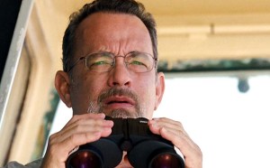Captain Phillips (Tom Hanks) on the look out for pirates... and worried by how quickly they're advancing toward his ship.