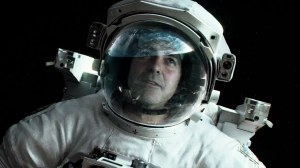 Matt (George Clooney), from behind his space helmet, gazing and admiring Earth, amidst the peace of outer space.