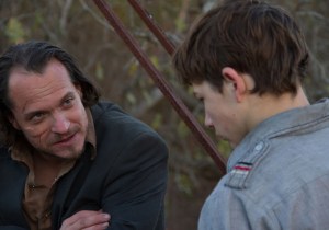 Gary speaking with Willie-Russell (Ronnie Gene Blevins). There is a reason why he has a scar under his right eye and Willie-Russell wants revenge against the man who did it.