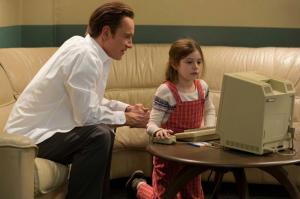 Steve Jobs playing on the Apple Macintosh with his daughter, Lisa (at aged five, played by Makenzie Moss).
