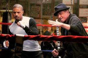 Rocky (Sylvester Stallone, right), giving his pupil, Adonis Creed (Michael B. Jordan, left), some advice on how to defeat a foe in the ring.