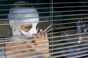 The mother (Susanne Wuest), her face bandaged up, but for her piercing blue eyes, looking outside creepily to see what her sons are up to.