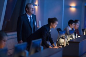 CIA Director Robert Dewey (Tommy Lee Jones) keeping close watch of his bent-forward protégé, Heather Lee (Alicia Vikander).