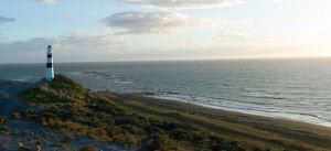 A stunning view of the lighthouse and the ocean from Janus Rock.