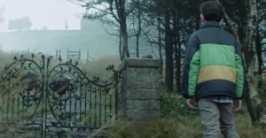 Conor (Lewis MacDougall) looking at the old yew tree in the distance, which is fabled to be a tree that can cure people.
